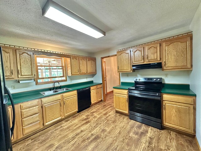 7532 Maysville Rd, Carlisle, KY 40311 - kitchen with black appliances, under cabinet range hood, a sink, light wood-style floors, and a textured ceiling