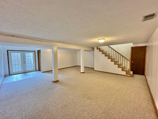 7532 Maysville Rd, Carlisle, KY 40311 - below grade area featuring light colored carpet, a textured ceiling, stairs, baseboards, and french doors