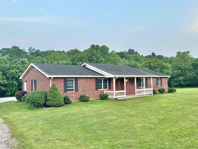 7532 Maysville Rd, Carlisle, KY 40311 - single story home featuring a porch, brick siding, a front lawn, and a forest view