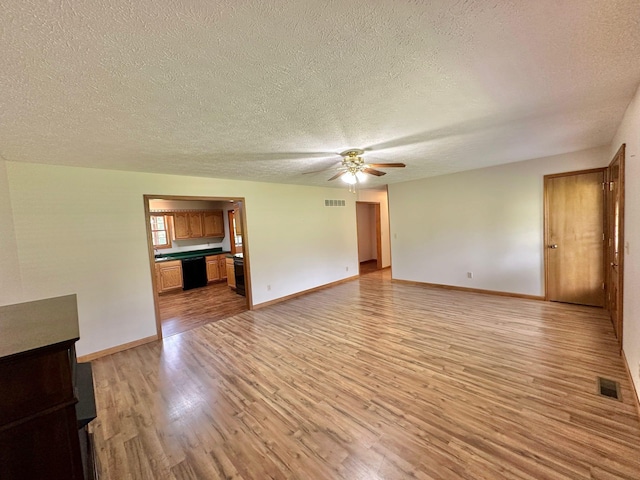 7532 Maysville Rd, Carlisle, KY 40311 - unfurnished living room featuring a ceiling fan, light wood-type flooring, a textured ceiling, and baseboards