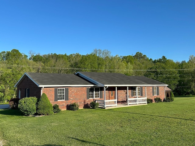 7532 Maysville Rd, Carlisle, KY 40311 - ranch-style home featuring covered porch, brick siding, a front yard, and a view of trees
