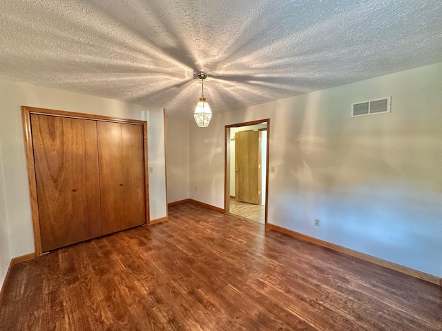 7532 Maysville Rd, Carlisle, KY 40311 - unfurnished bedroom featuring dark wood finished floors, baseboards, a textured ceiling, a closet, and ceiling fan