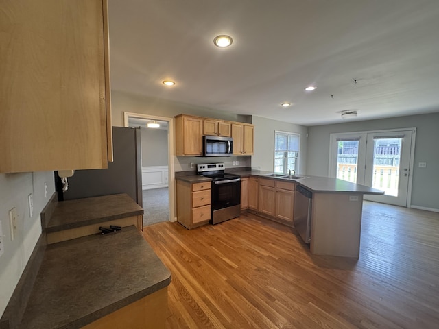 3017 Polo Club Blvd, Lexington, KY 40509 - kitchen with stainless steel appliances, a peninsula, dark countertops, recessed lighting, and light wood-type flooring