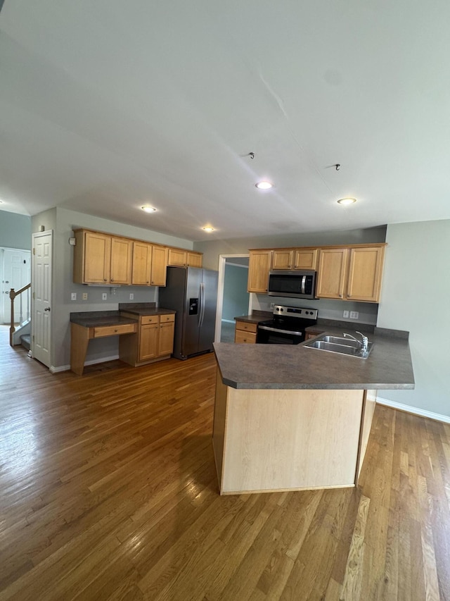 3017 Polo Club Blvd, Lexington, KY 40509 - kitchen with appliances with stainless steel finishes, a sink, dark countertops, dark wood-type flooring, and a peninsula