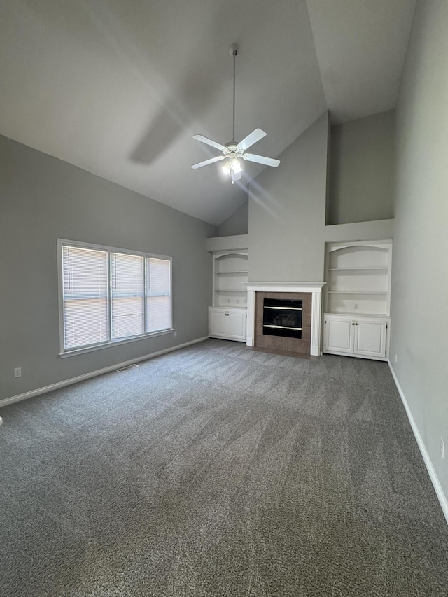 3017 Polo Club Blvd, Lexington, KY 40509 - unfurnished living room with dark carpet, a ceiling fan, baseboards, a tile fireplace, and high vaulted ceiling