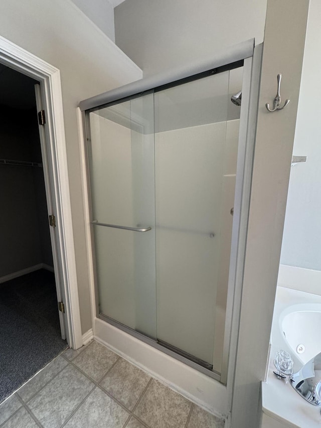 3017 Polo Club Blvd, Lexington, KY 40509 - bathroom with a stall shower, a walk in closet, and tile patterned floors