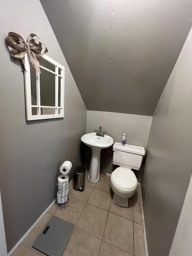 104 Steele St, Corbin, KY 40701 - bathroom featuring lofted ceiling, toilet, tile patterned flooring, a sink, and baseboards