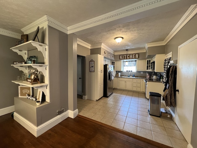 104 Steele St, Corbin, KY 40701 - kitchen with appliances with stainless steel finishes, a textured ceiling, crown molding, a sink, and baseboards