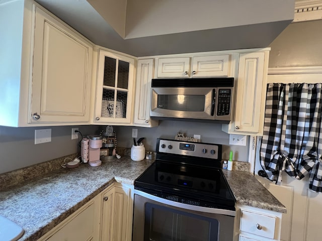 104 Steele St, Corbin, KY 40701 - kitchen featuring appliances with stainless steel finishes, glass insert cabinets, and white cabinets