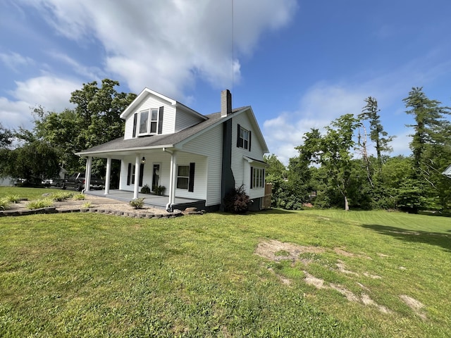 104 Steele St, Corbin, KY 40701 - view of front facade featuring a chimney, a front lawn, and covered porch