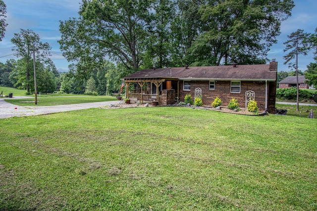 1540 Stoney Fork Rd, Corbin, KY 40701 - view of front of house featuring a front yard, a chimney, a porch, and brick siding