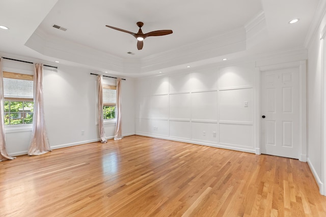 2128 Leafland Pl, Lexington, KY 40515 - empty room featuring a raised ceiling, crown molding, plenty of natural light, ceiling fan, and light wood-style flooring