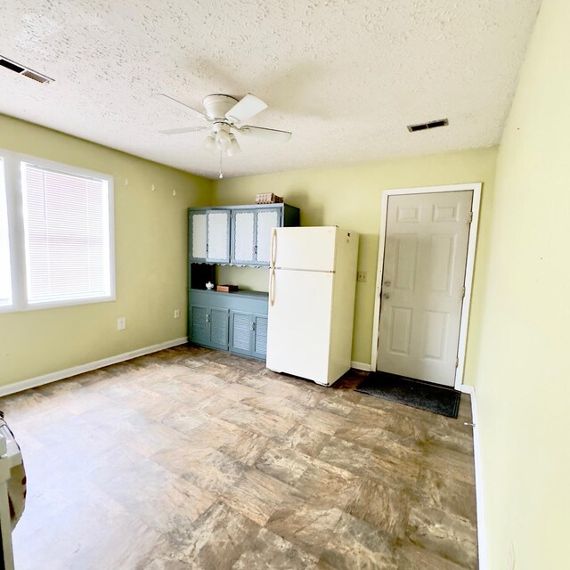 630 Blakely Rd, London, KY 40744 - kitchen with freestanding refrigerator, a ceiling fan, a textured ceiling, and baseboards
