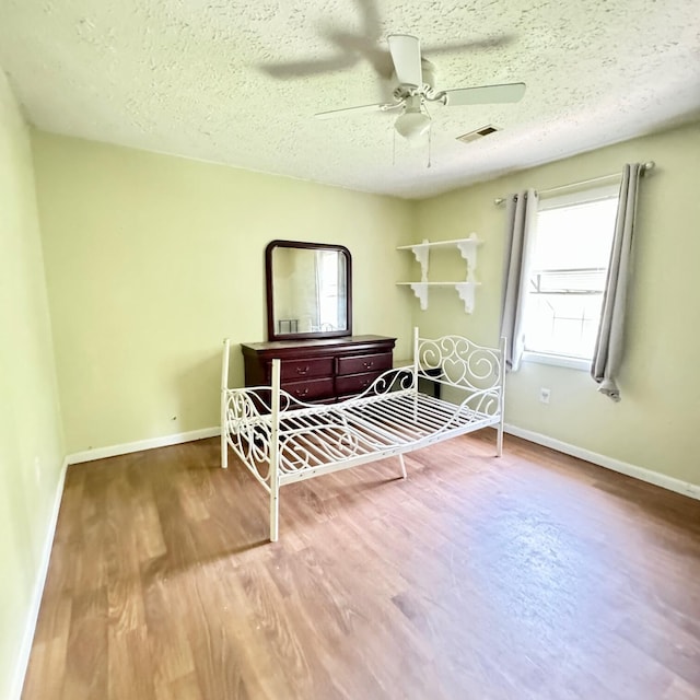 630 Blakely Rd, London, KY 40744 - bedroom with wood finished floors, baseboards, a textured ceiling, and a ceiling fan