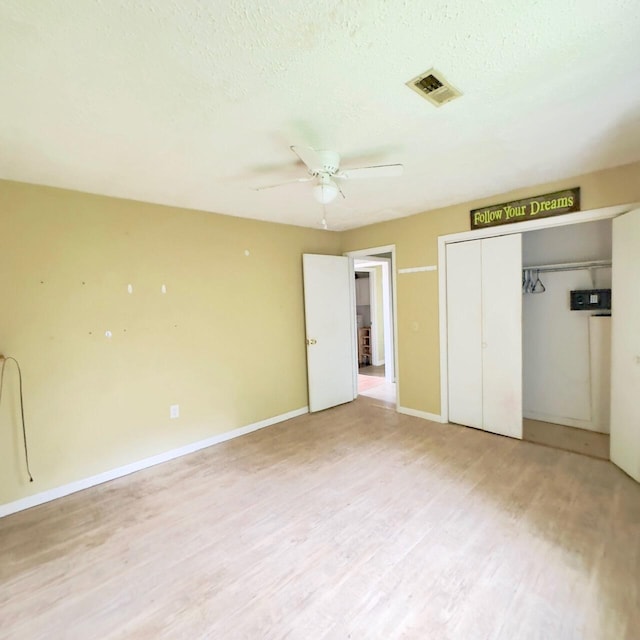630 Blakely Rd, London, KY 40744 - unfurnished bedroom featuring light wood-type flooring, a closet, baseboards, a ceiling fan, and a textured ceiling