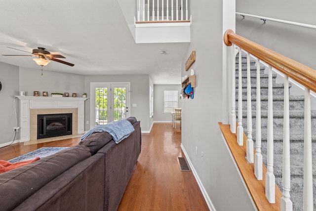 962 Cobble Dr, Richmond, KY 40475 - living room featuring ceiling fan, stairs, baseboards, wood finished floors, and a tiled fireplace