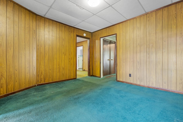 522 Atwood St, Louisville, KY 40217 - carpeted empty room with wood walls and a paneled ceiling