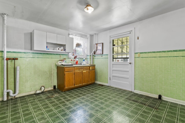 522 Atwood St, Louisville, KY 40217 - kitchen with tile walls, dark floors, a wainscoted wall, open shelves, and brown cabinets