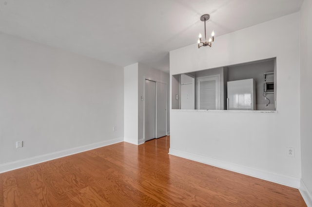 2121 Nicholasville Rd Unit 910, Lexington, KY 40503 - unfurnished room with a chandelier, wood finished floors, and baseboards