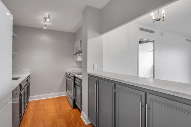 2121 Nicholasville Rd Unit 910, Lexington, KY 40503 - kitchen with appliances with stainless steel finishes, under cabinet range hood, gray cabinetry, and light wood finished floors