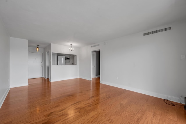 2121 Nicholasville Rd Unit 910, Lexington, KY 40503 - unfurnished living room featuring wood finished floors and baseboards