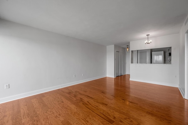 2121 Nicholasville Rd Unit 910, Lexington, KY 40503 - unfurnished room with a chandelier, wood finished floors, and baseboards