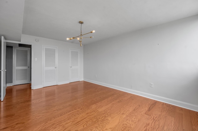 2121 Nicholasville Rd Unit 910, Lexington, KY 40503 - unfurnished room featuring a chandelier, baseboards, and wood finished floors