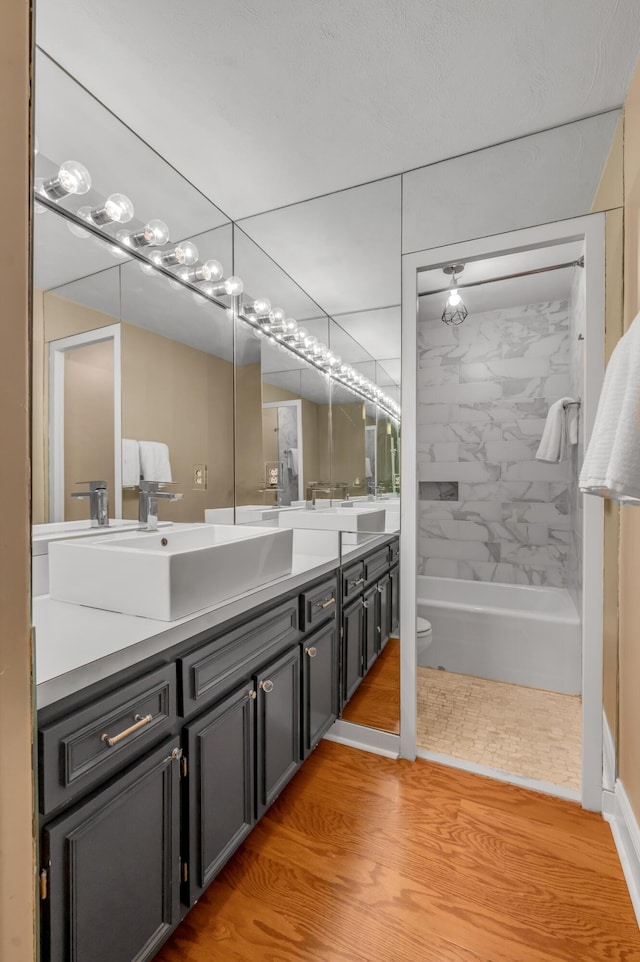 2121 Nicholasville Rd Unit 910, Lexington, KY 40503 - full bath featuring double vanity, toilet, wood finished floors, and shower / bathtub combination