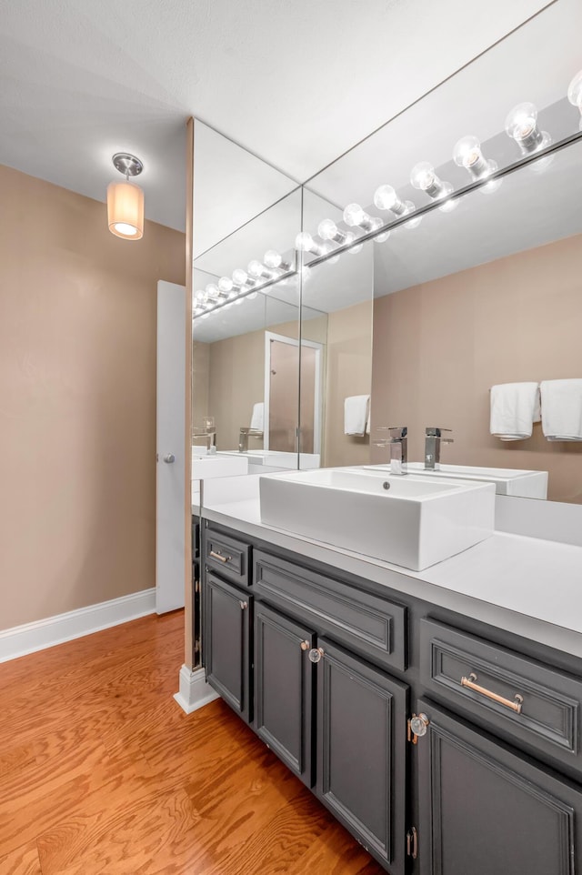 2121 Nicholasville Rd Unit 910, Lexington, KY 40503 - bathroom with vanity, wood finished floors, and baseboards