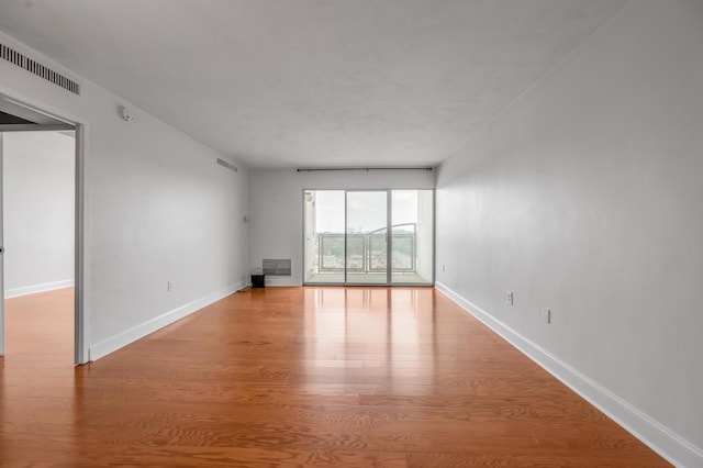 2121 Nicholasville Rd Unit 910, Lexington, KY 40503 - unfurnished living room featuring wood finished floors and baseboards