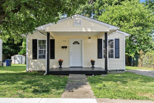 330 Corral St, Lexington, KY 40508 - bungalow with a porch, a front lawn, and a storage unit