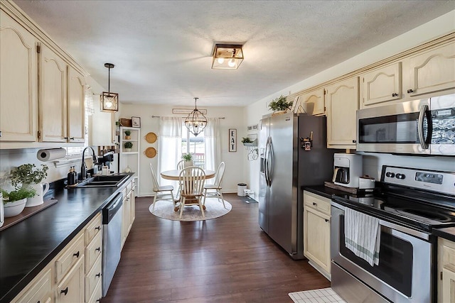 105 Geneva Ct, Nicholasville, KY 40356 - kitchen with appliances with stainless steel finishes, a sink, dark countertops, dark wood-style floors, and a chandelier