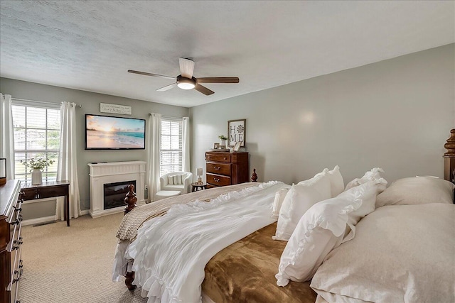 105 Geneva Ct, Nicholasville, KY 40356 - bedroom with a glass covered fireplace, light carpet, and ceiling fan