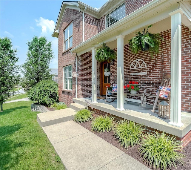 105 Geneva Ct, Nicholasville, KY 40356 - entrance to property with brick siding, covered porch, and a lawn