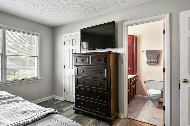400 Aspen Dr, Lawrenceburg, KY 40342 - bedroom featuring wood finished floors, multiple windows, a textured ceiling, and ensuite bathroom