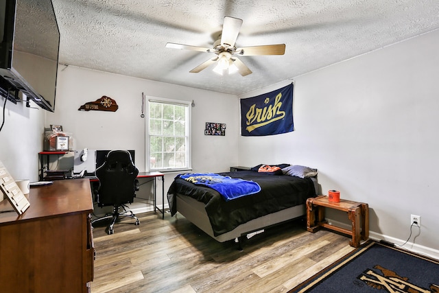 400 Aspen Dr, Lawrenceburg, KY 40342 - bedroom with wood finished floors, an office area, a textured ceiling, and ceiling fan