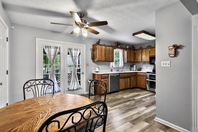 400 Aspen Dr, Lawrenceburg, KY 40342 - kitchen with appliances with stainless steel finishes, light countertops, ceiling fan, wood finished floors, and brown cabinetry