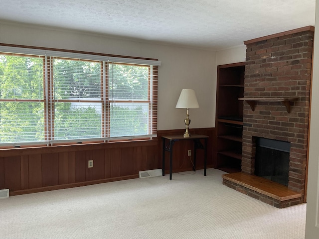 411 Ohara Dr, Danville, KY 40422 - living area with carpet floors, healthy amount of natural light, a textured ceiling, a brick fireplace, and wood walls