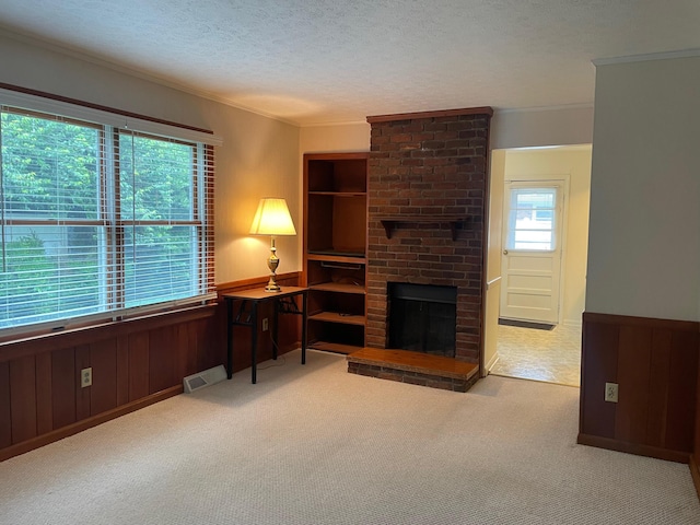 411 Ohara Dr, Danville, KY 40422 - living room featuring carpet, a textured ceiling, ornamental molding, wainscoting, and a fireplace