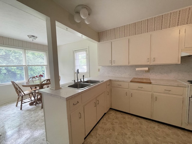 411 Ohara Dr, Danville, KY 40422 - kitchen with light countertops, a peninsula, light floors, and white cabinets