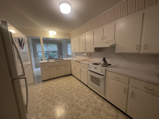 411 Ohara Dr, Danville, KY 40422 - kitchen with white appliances, light flooring, under cabinet range hood, light countertops, and white cabinetry