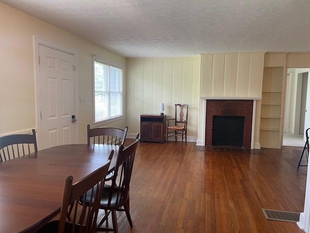 411 Ohara Dr, Danville, KY 40422 - dining area with wood-type flooring, a textured ceiling, and a fireplace