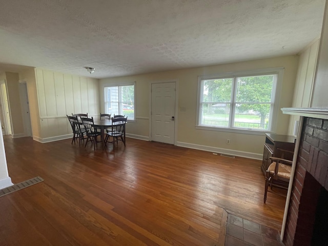 411 Ohara Dr, Danville, KY 40422 - dining room with a fireplace, a textured ceiling, and wood finished floors