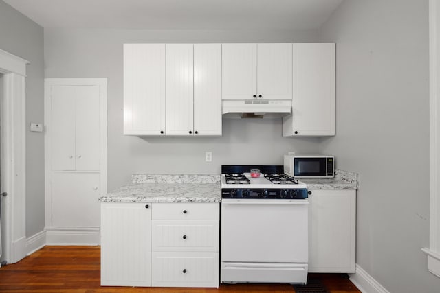611 Old Shakertown Rd, Danville, KY 40422 - kitchen with white gas range, under cabinet range hood, baseboards, and dark wood finished floors
