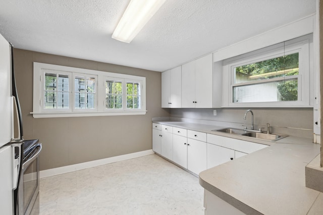 611 Old Shakertown Rd, Danville, KY 40422 - kitchen featuring a sink, electric stove, white cabinets, plenty of natural light, and a textured ceiling