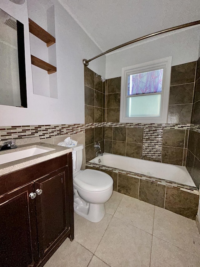 324 Glendale Ave, Lexington, KY 40511 - full bathroom featuring tile walls, vanity, tiled shower / bath combo, tile patterned floors, and toilet