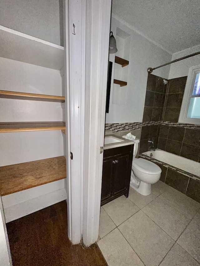 324 Glendale Ave, Lexington, KY 40511 - bathroom with tiled shower / bath combo, vanity, toilet, and tile patterned flooring