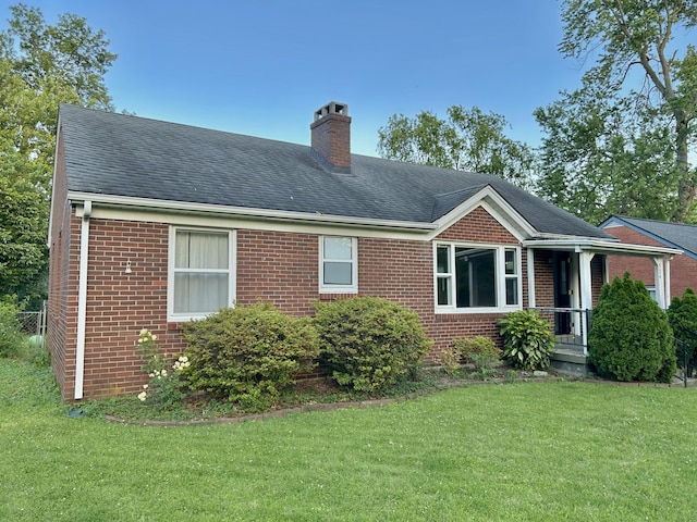 324 Glendale Ave, Lexington, KY 40511 - view of front of home featuring brick siding, a chimney, a front yard, and roof with shingles