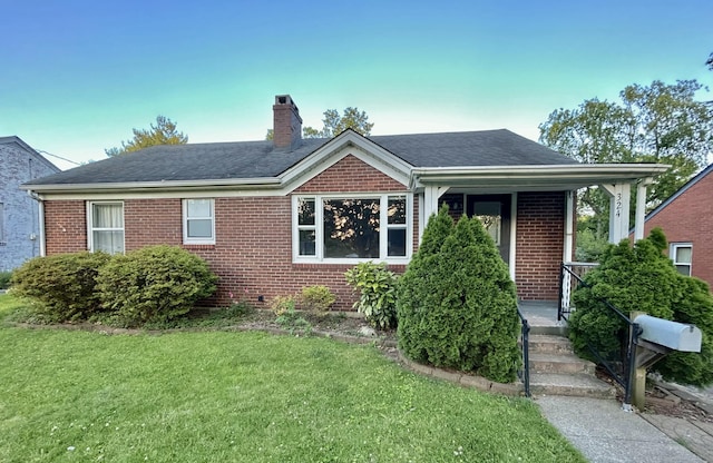 324 Glendale Ave, Lexington, KY 40511 - view of front of property with brick siding, a chimney, a front yard, and roof with shingles
