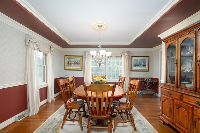 202 Thoroughbred Ln, Nicholasville, KY 40356 - dining space with a chandelier, healthy amount of natural light, wood finished floors, crown molding, and wallpapered walls